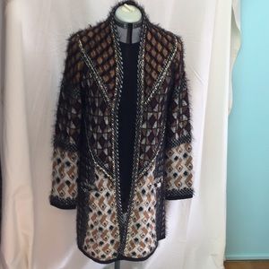 Sweater, harlequin design, gold chain accents.